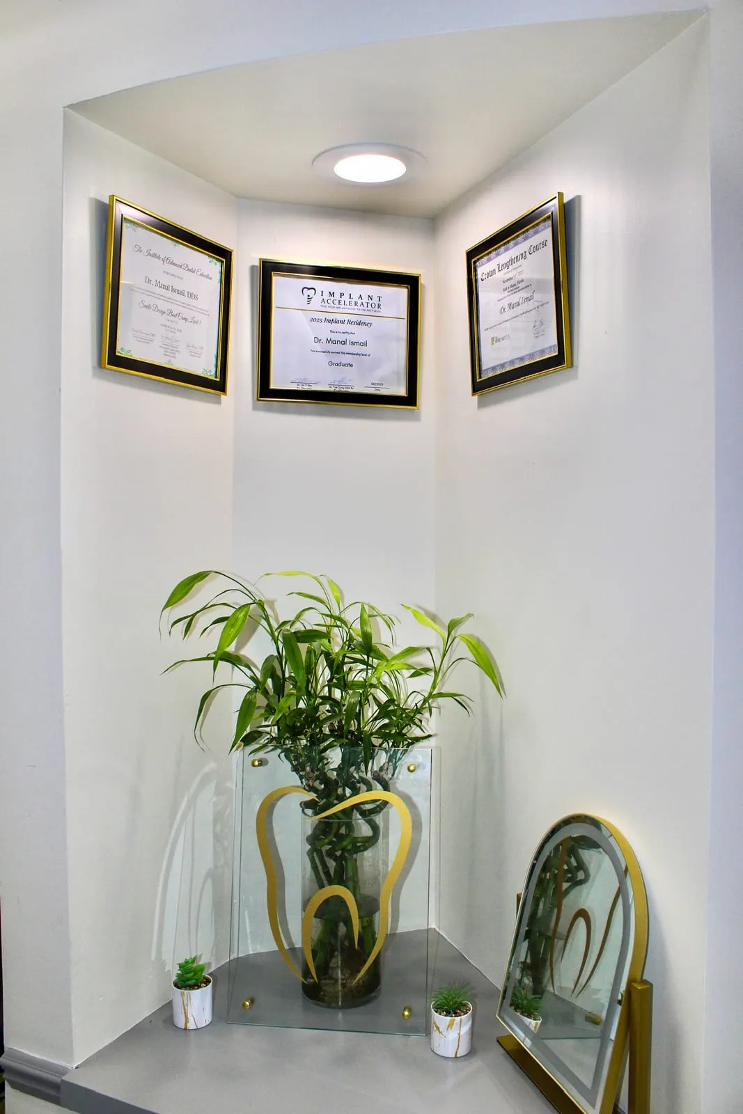 Dental certifications for Dr. Manal Ismail displayed at Royal Dental Center