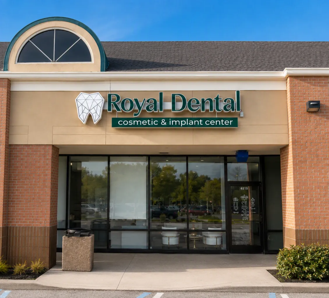 The Royal Dental Center building on Haggerty Road, a brick storefront with an arched window above the entrance and the Royal Dental cosmetic and implant center sign over the glass doors.