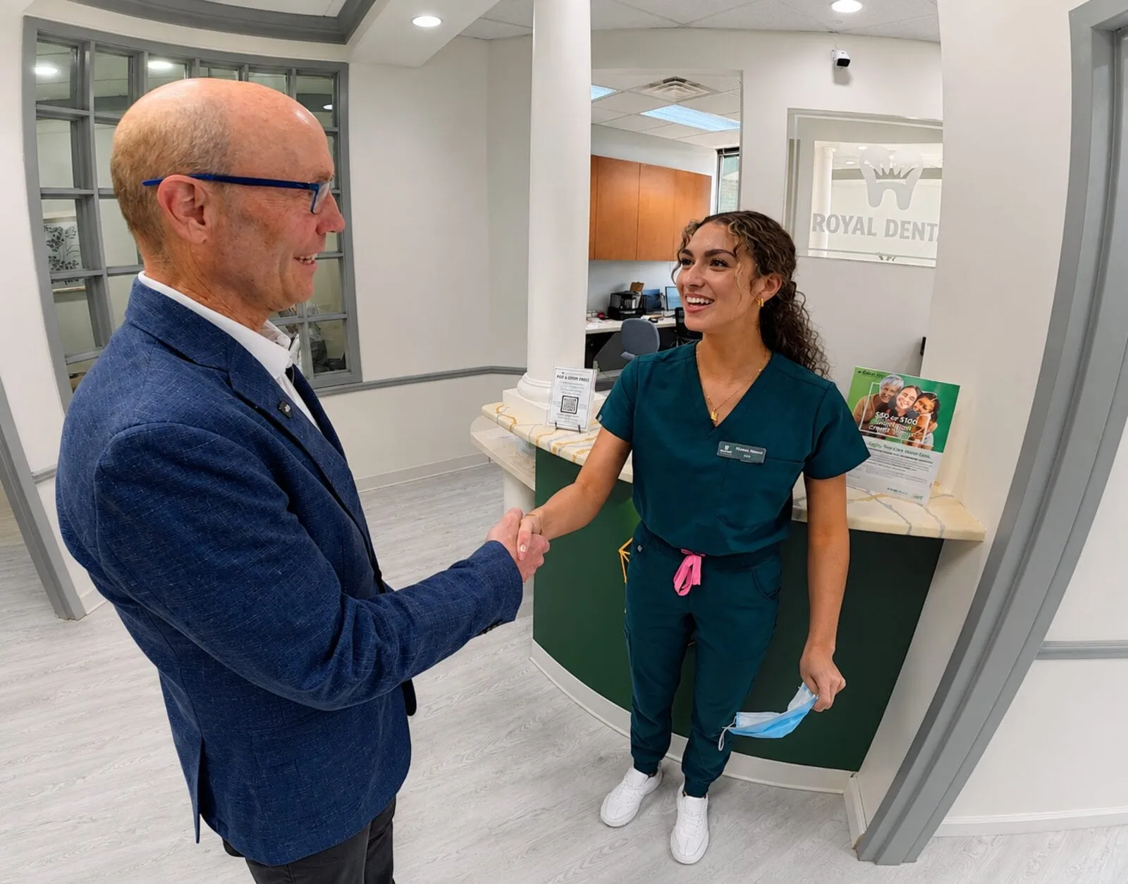 A Royal Dental Center team member welcoming a patient at the front desk