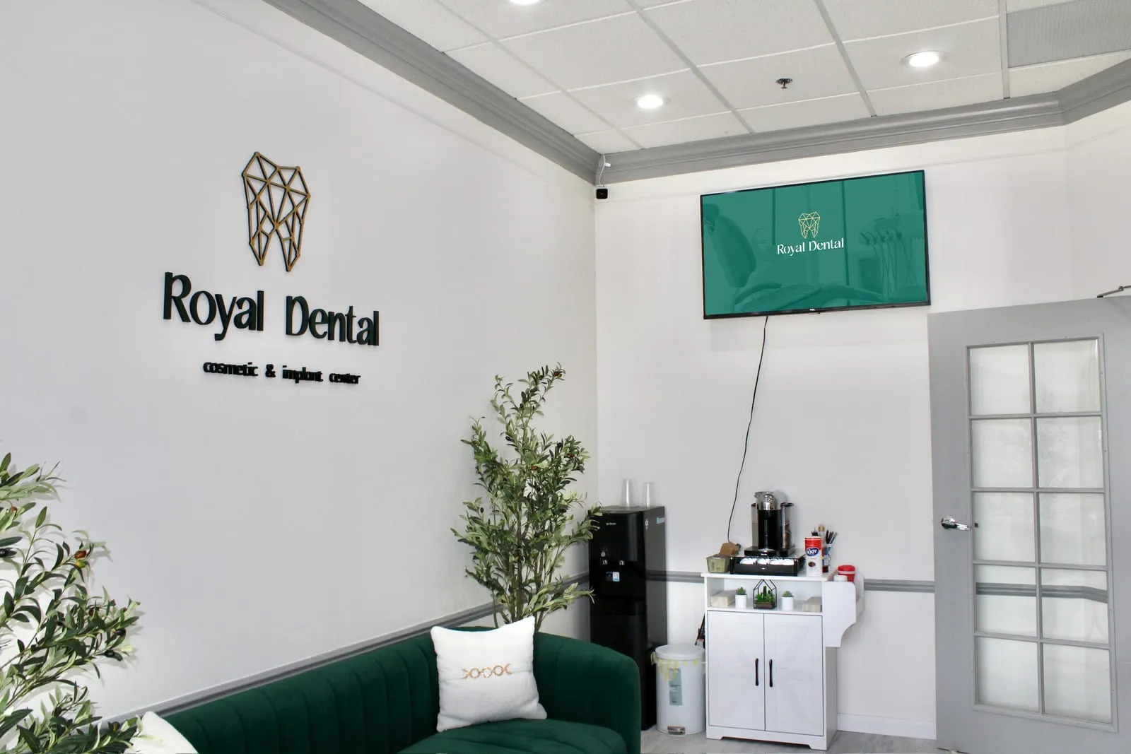 The waiting lounge and complimentary coffee station at Royal Dental Center