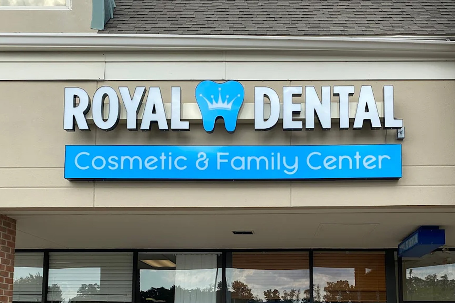 The image shows a storefront with a sign that reads  Royal Dental Cosmetic   Family Center  above an entrance, indicating a dental practice specializing in cosmetic and family dentistry.