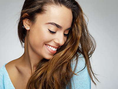 The image features a woman with long hair smiling at the camera, with two separate photos placed side by side.